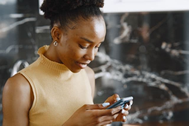 A woman checking her finances on her phone